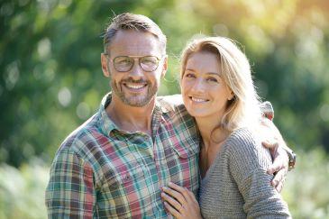 Man and woman smiling with dental implants, Lindenhurst NY