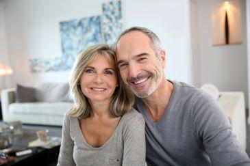 Older couple smiling after cosmetic dentistry treatment, Lindenhurst NY