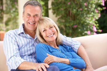 Older man and woman smiling with dentures, Lindenhurst NY