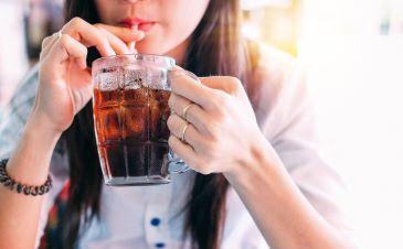 Woman drinking soda with a straw, Lindenhurst NY