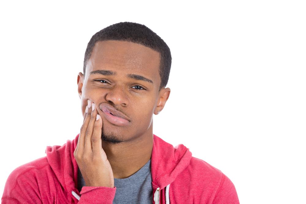 Black man holding his jaw in pain, lindenhurst ny