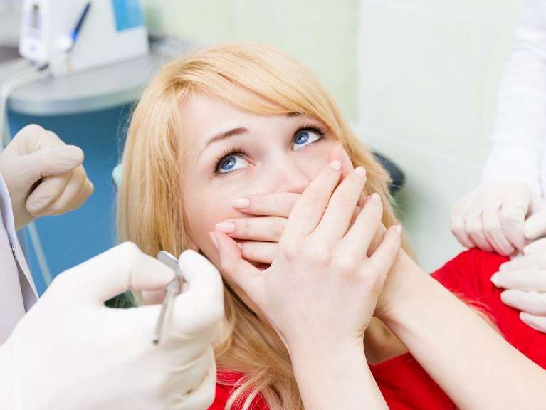 Blonde woman holding her mouth, lindenhurst ny