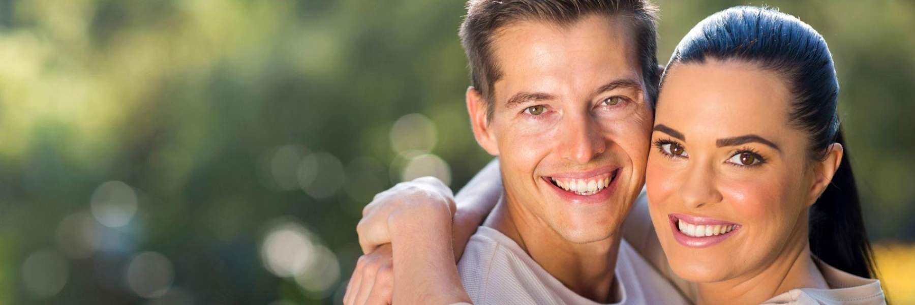 Man and woman smiling after cosmetic dentistry, Lindenhurst NY