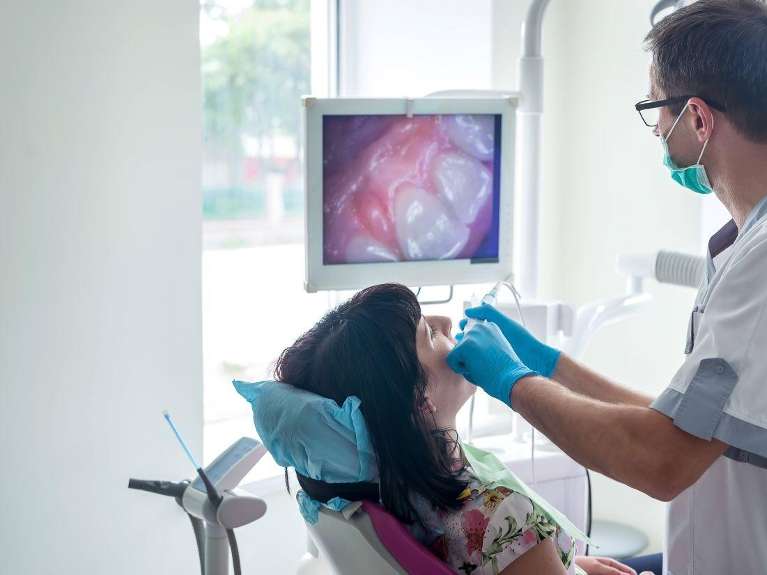 An intraoral camera being used on a patient in a dentists office, Lindenhurst NY